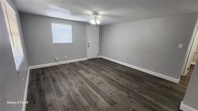 wooden floor in an empty room with a window