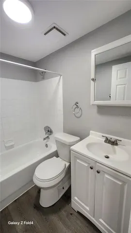 a bathroom with a toilet a sink and bathtub