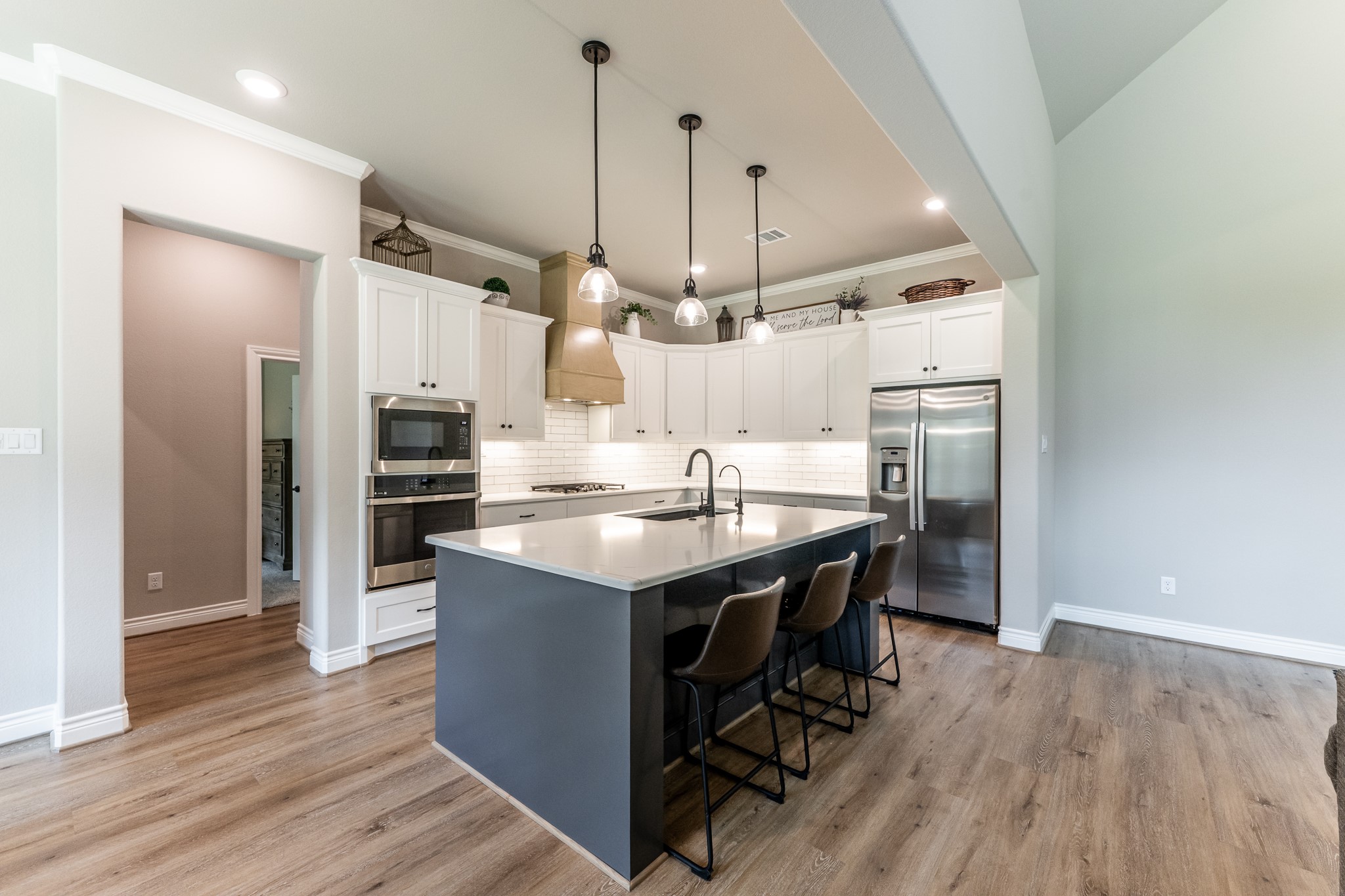 111 Eagle Run Road Willis, TX 77378 - Photo 12 of 44 Experience culinary delight in this modern island kitchen, featuring a sleek breakfast bar perfect for casual dining or entertaining.