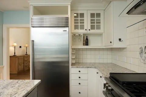 a stove top oven sitting inside of a kitchen