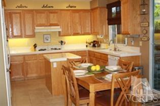 4912 Borders Street Simi Valley, CA 93063 - Photo 2 of 10 a kitchen with stainless steel appliances a sink a stove and a refrigerator