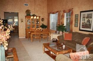 4912 Borders Street Simi Valley, CA 93063 - Photo 4 of 10 a living room with furniture a chandelier and a dining table