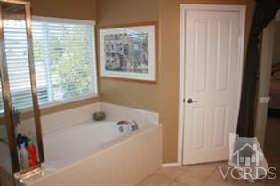 4912 Borders Street Simi Valley, CA 93063 - Photo 6 of 10 a bathroom with a bathtub and a window