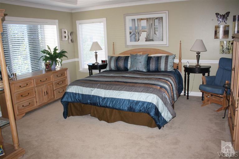 4912 Borders Street Simi Valley, CA 93063 - Photo 7 of 10 a spacious bedroom with a large bed and a window