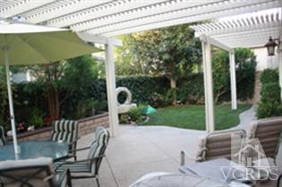 4912 Borders Street Simi Valley, CA 93063 - Photo 10 of 10 a view of a patio with a table chairs and a backyard