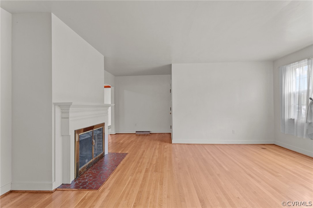 2916 Sherbourne Road North Chesterfield, VA 23237 - Photo 5 of 43 an empty room with wooden floor and fireplace