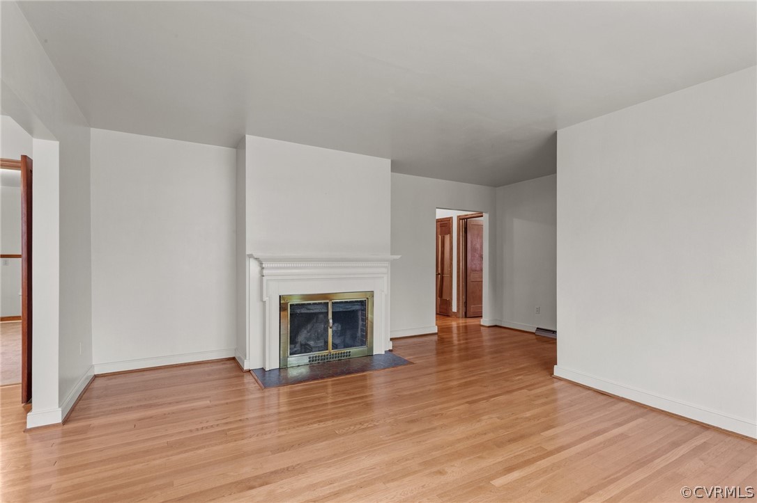 2916 Sherbourne Road North Chesterfield, VA 23237 - Photo 6 of 43 a view of an empty room with wooden floor fireplace and a window