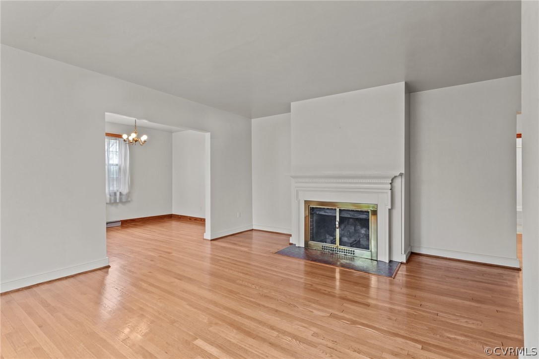 2916 Sherbourne Road North Chesterfield, VA 23237 - Photo 7 of 43 an empty room with wooden floor fireplace and windows
