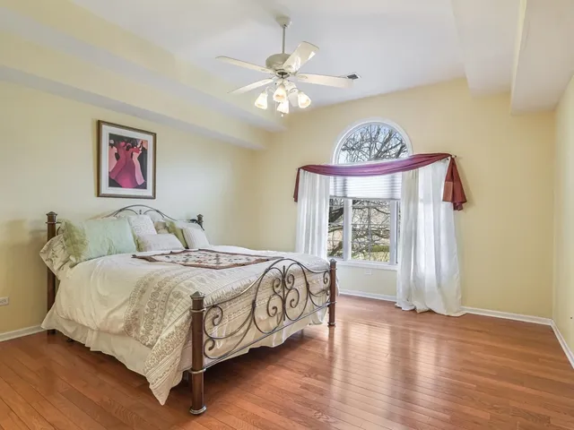 a bedroom with a large bed and a chandelier