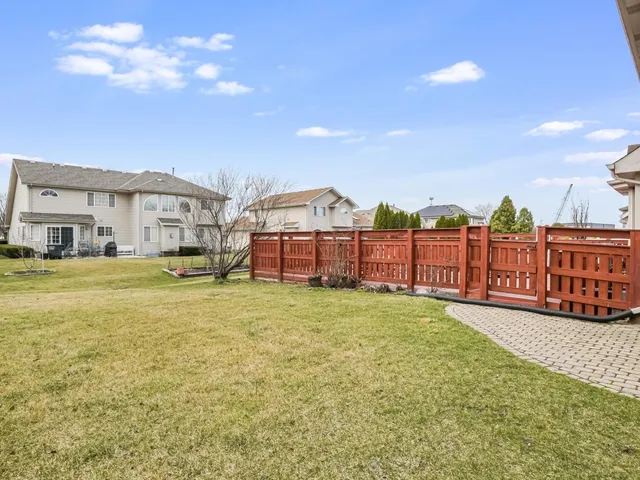 a view of a house with wooden fence