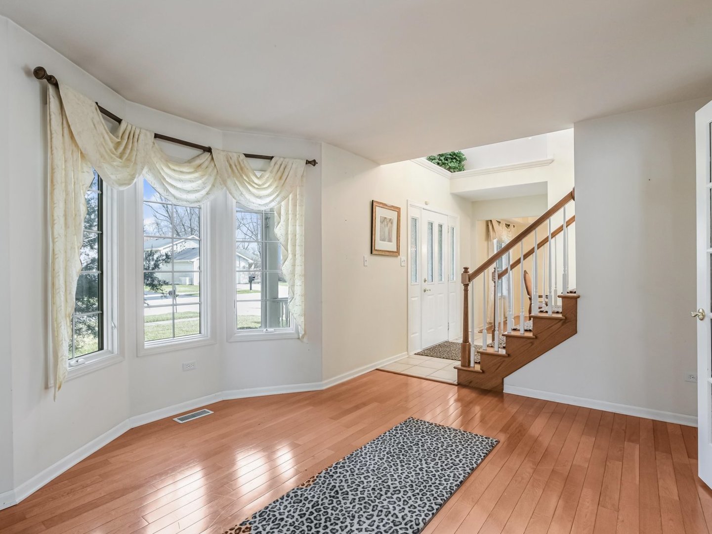 18036 Crystal Lane Lansing, IL 60438 - Photo 3 of 46 a view of an entryway with wooden floor and windows