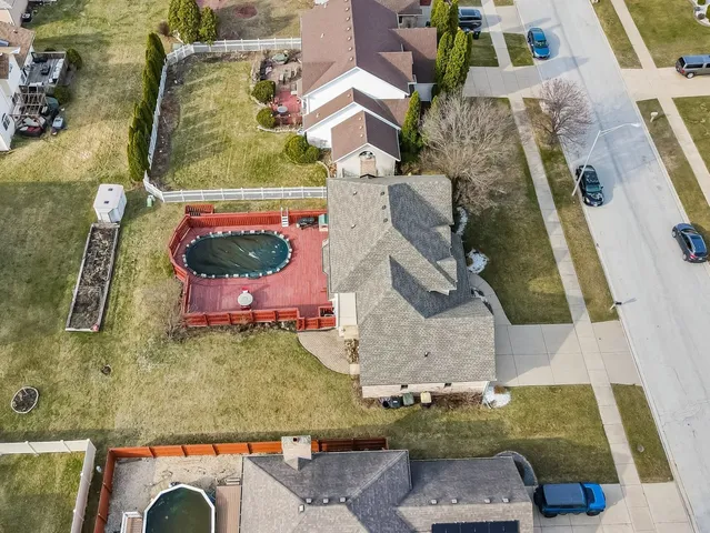 an aerial view of a house with a yard