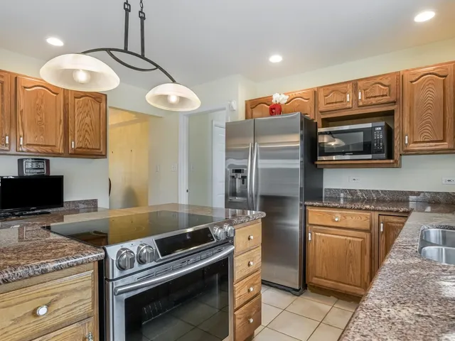 a kitchen with stainless steel appliances granite countertop a stove and a sink