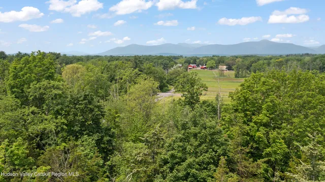 a view of a lake and green valley