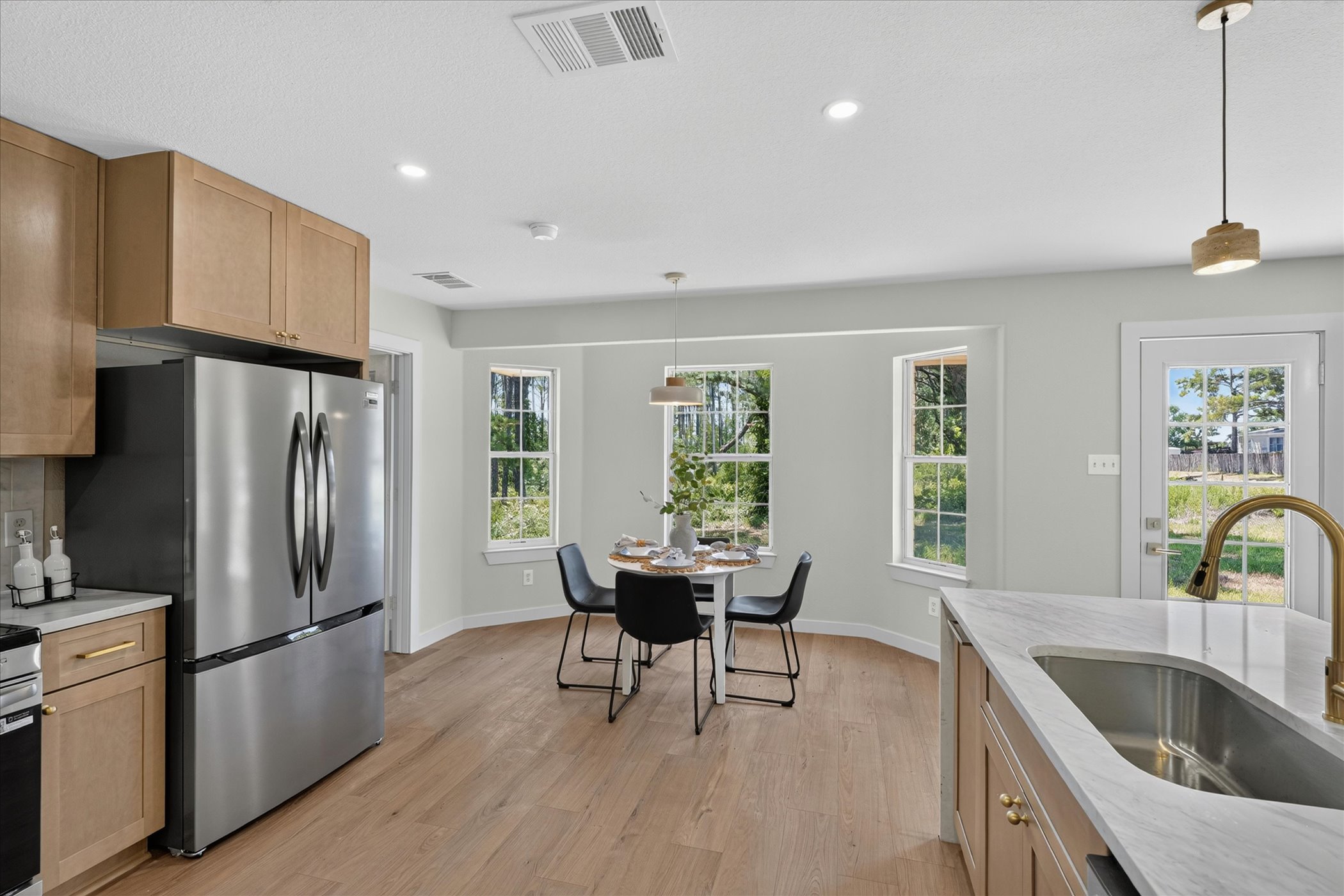 258 Pine View Loop Bastrop, TX 78602 - Photo 25 of 40 Well-lit kitchen with sleek countertops, modern appliances, and a charming breakfast nook.