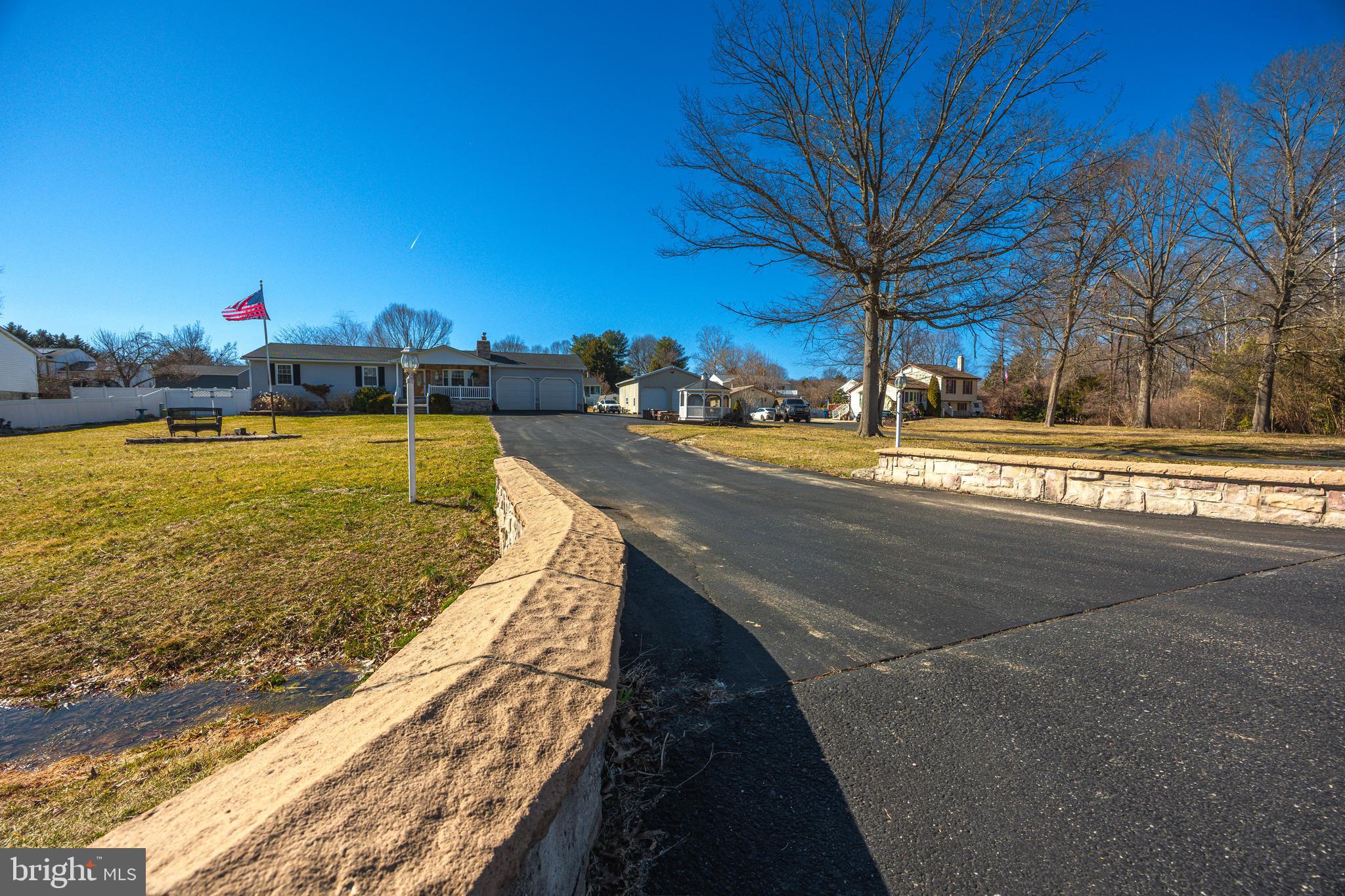 716 Paradise Road Aberdeen, MD 21001 - Photo 13 of 85 a view of a swimming pool with a lawn chairs under an umbrella