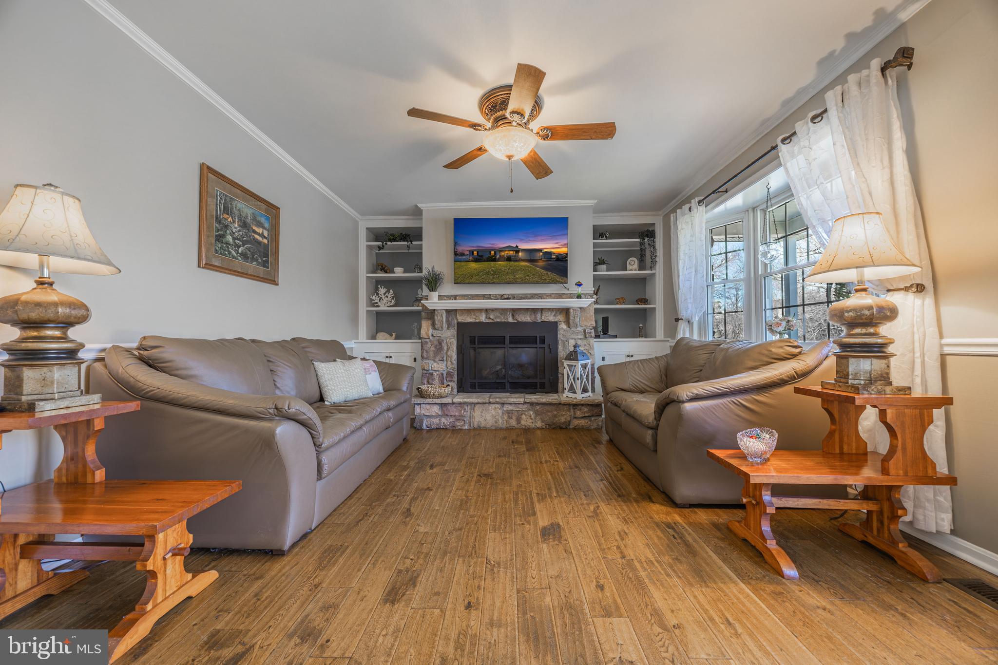 716 Paradise Road Aberdeen, MD 21001 - Photo 32 of 85 a living room with furniture a flat screen tv and a fireplace