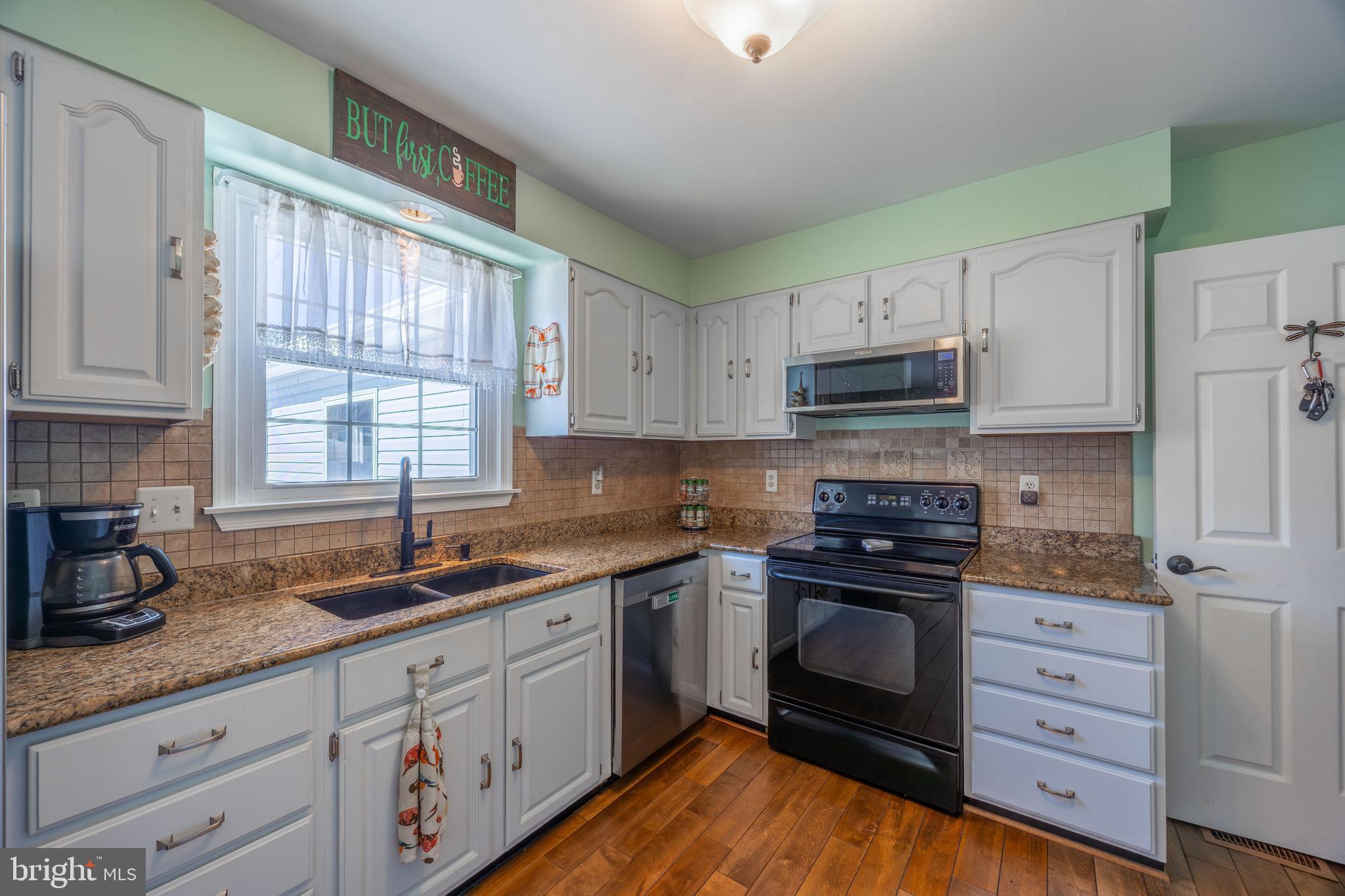 716 Paradise Road Aberdeen, MD 21001 - Photo 42 of 85 a kitchen with granite countertop a sink stainless steel appliances and cabinets