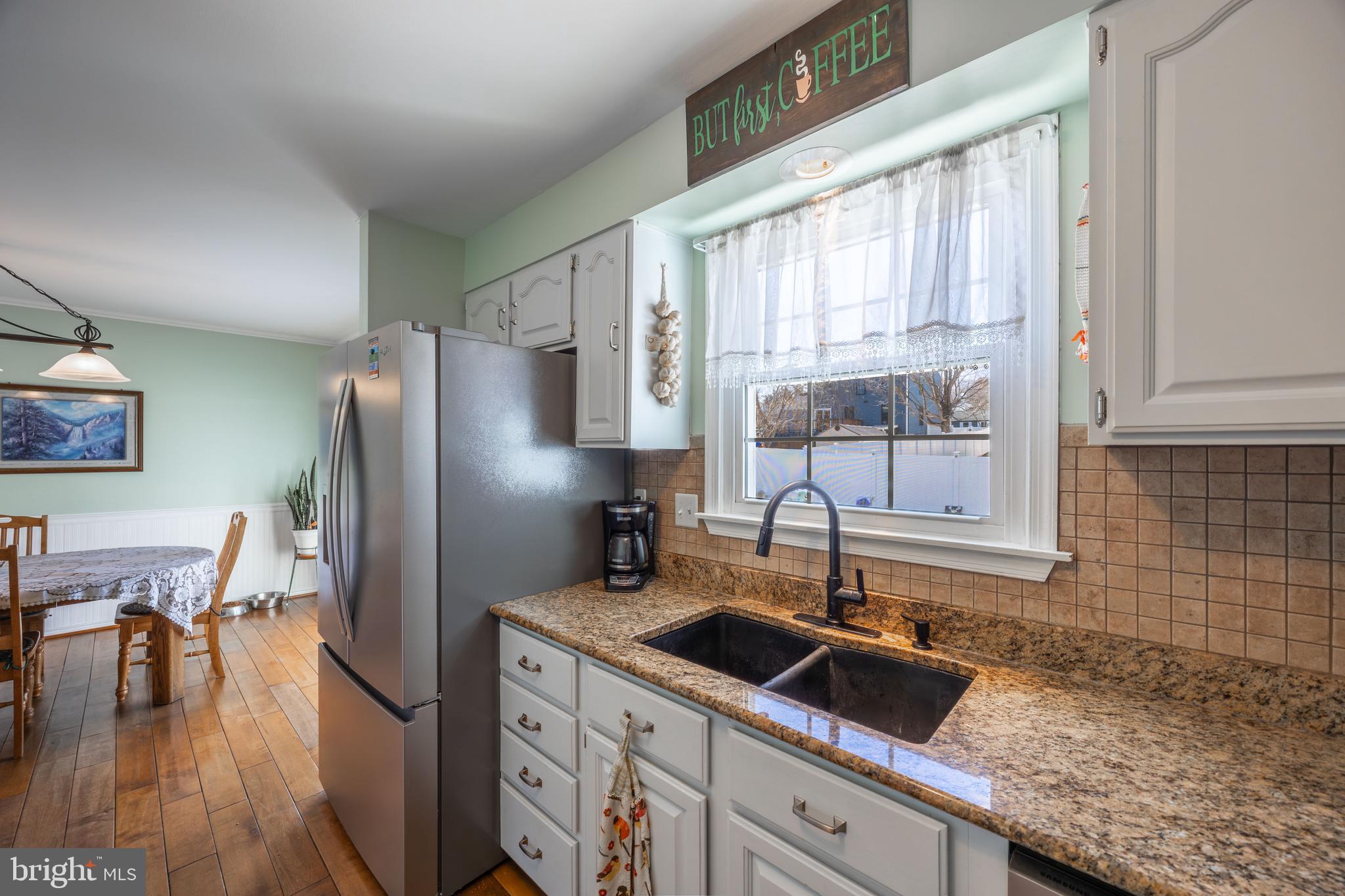 716 Paradise Road Aberdeen, MD 21001 - Photo 44 of 85 a kitchen with stainless steel appliances granite countertop a sink refrigerator and cabinets