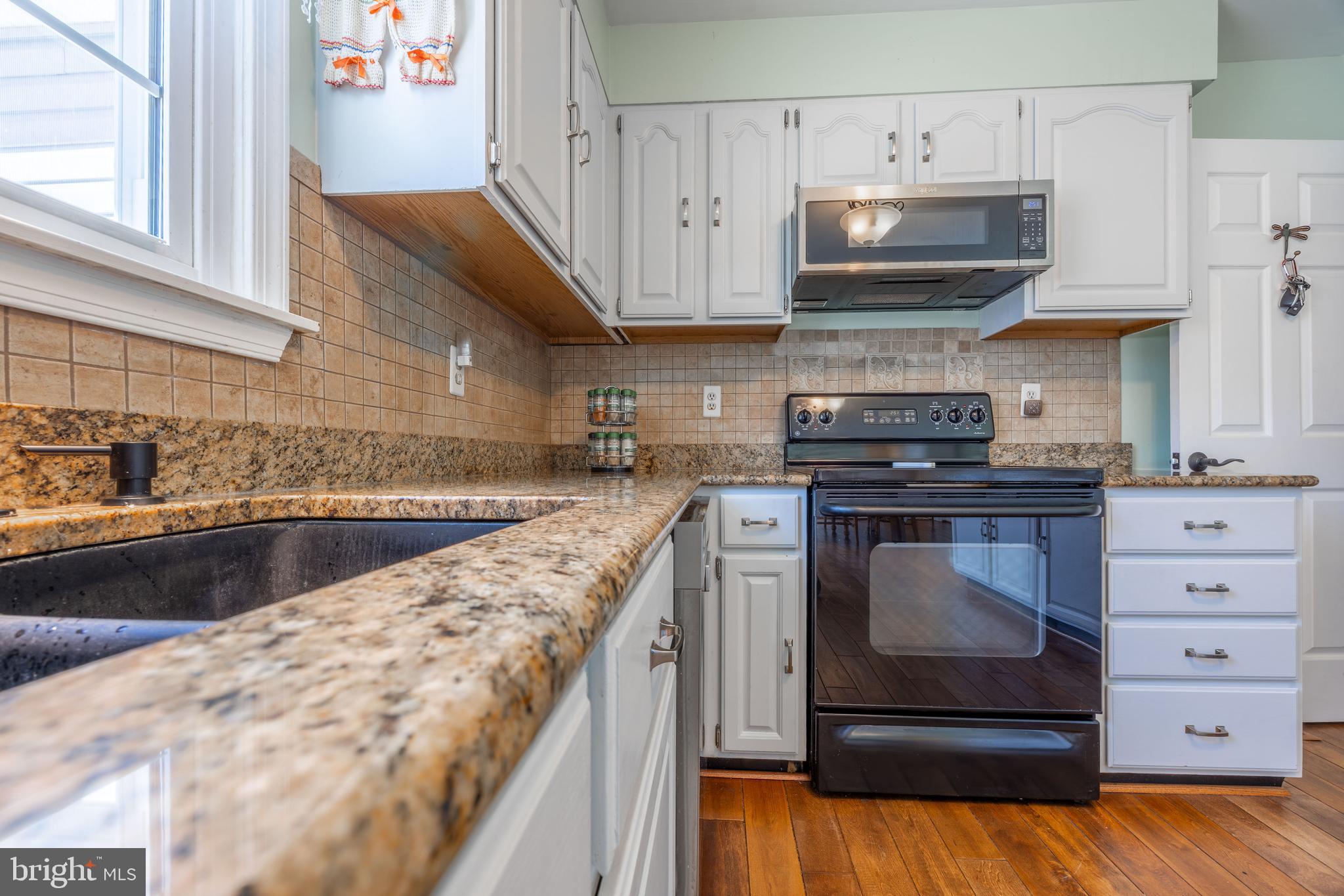 716 Paradise Road Aberdeen, MD 21001 - Photo 47 of 85 a kitchen with stainless steel appliances granite countertop a stove and a microwave