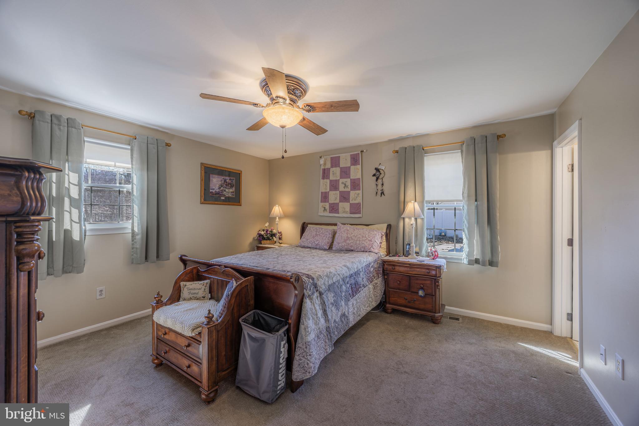 716 Paradise Road Aberdeen, MD 21001 - Photo 58 of 85 a spacious bedroom with a bed and a chandelier