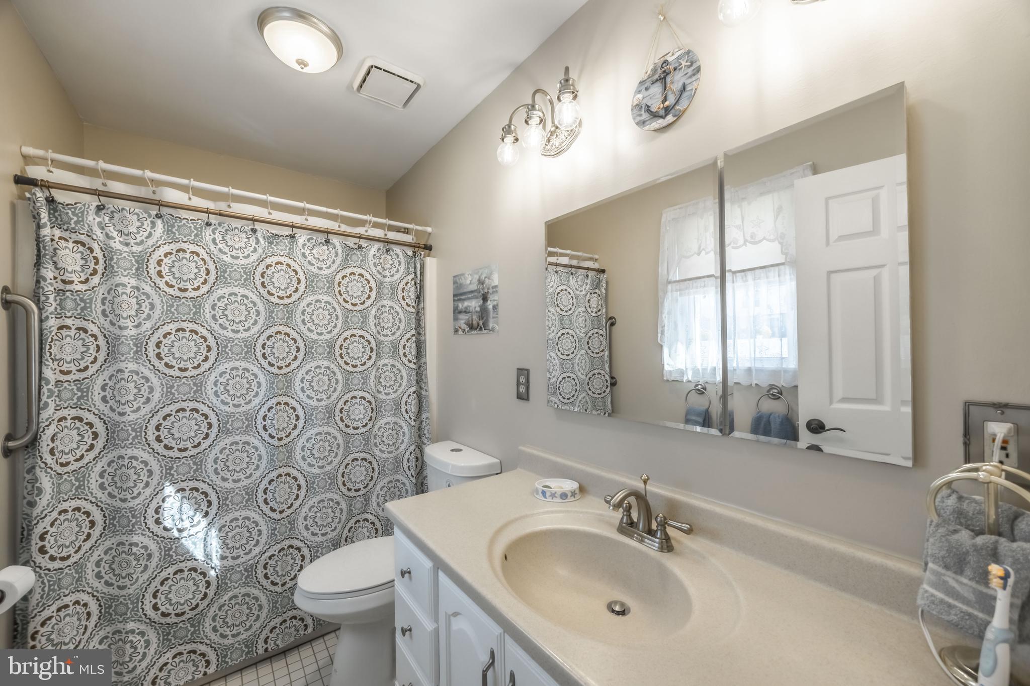716 Paradise Road Aberdeen, MD 21001 - Photo 61 of 85 a bathroom with a sink and mirror with toilet