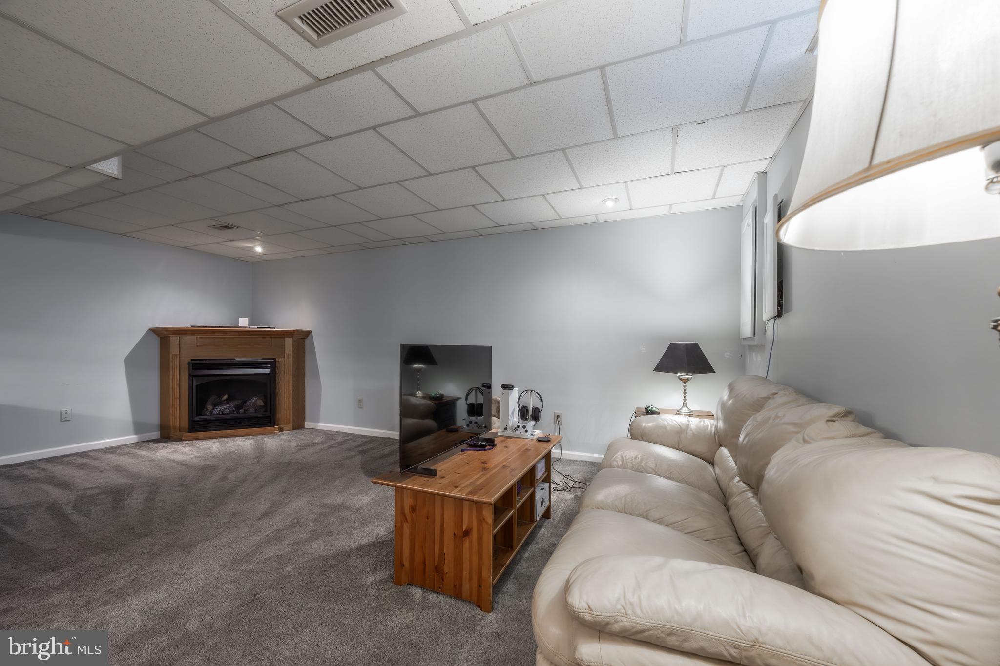716 Paradise Road Aberdeen, MD 21001 - Photo 78 of 85 a living room with furniture a fireplace and a flat screen tv