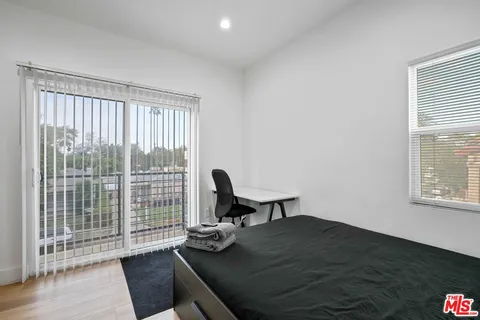 a view of a workspace room with furniture and window