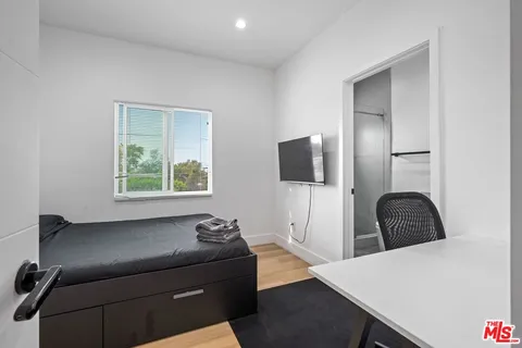 a bathroom with a shower sink vanity mirror and toilet