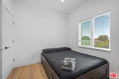 a living room with hard wood floor and white walls