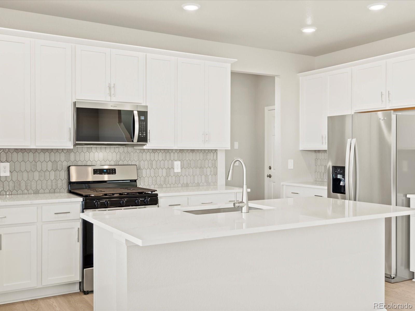 851 Frst Cyn Road Severance, CO 80550 - Photo 13 of 37 a kitchen with a sink a stove and refrigerator