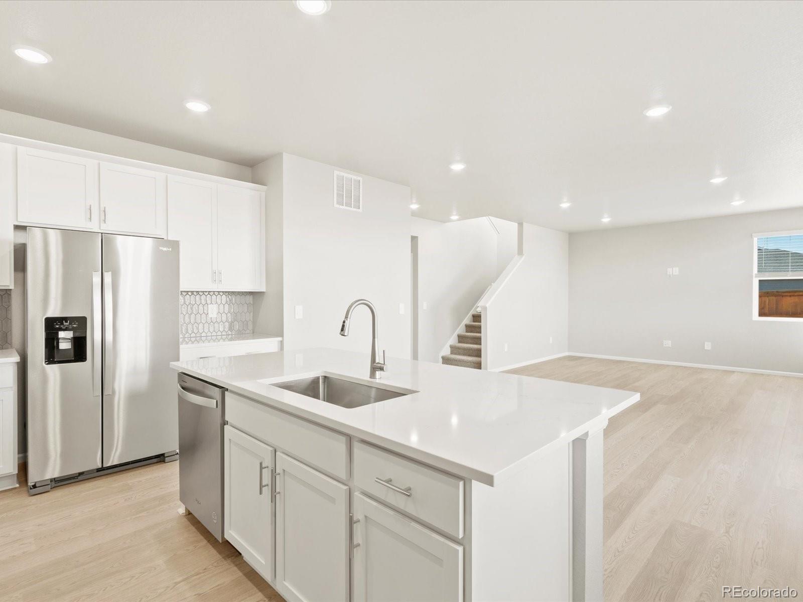 851 Frst Cyn Road Severance, CO 80550 - Photo 14 of 37 a kitchen with sink cabinets and refrigerator
