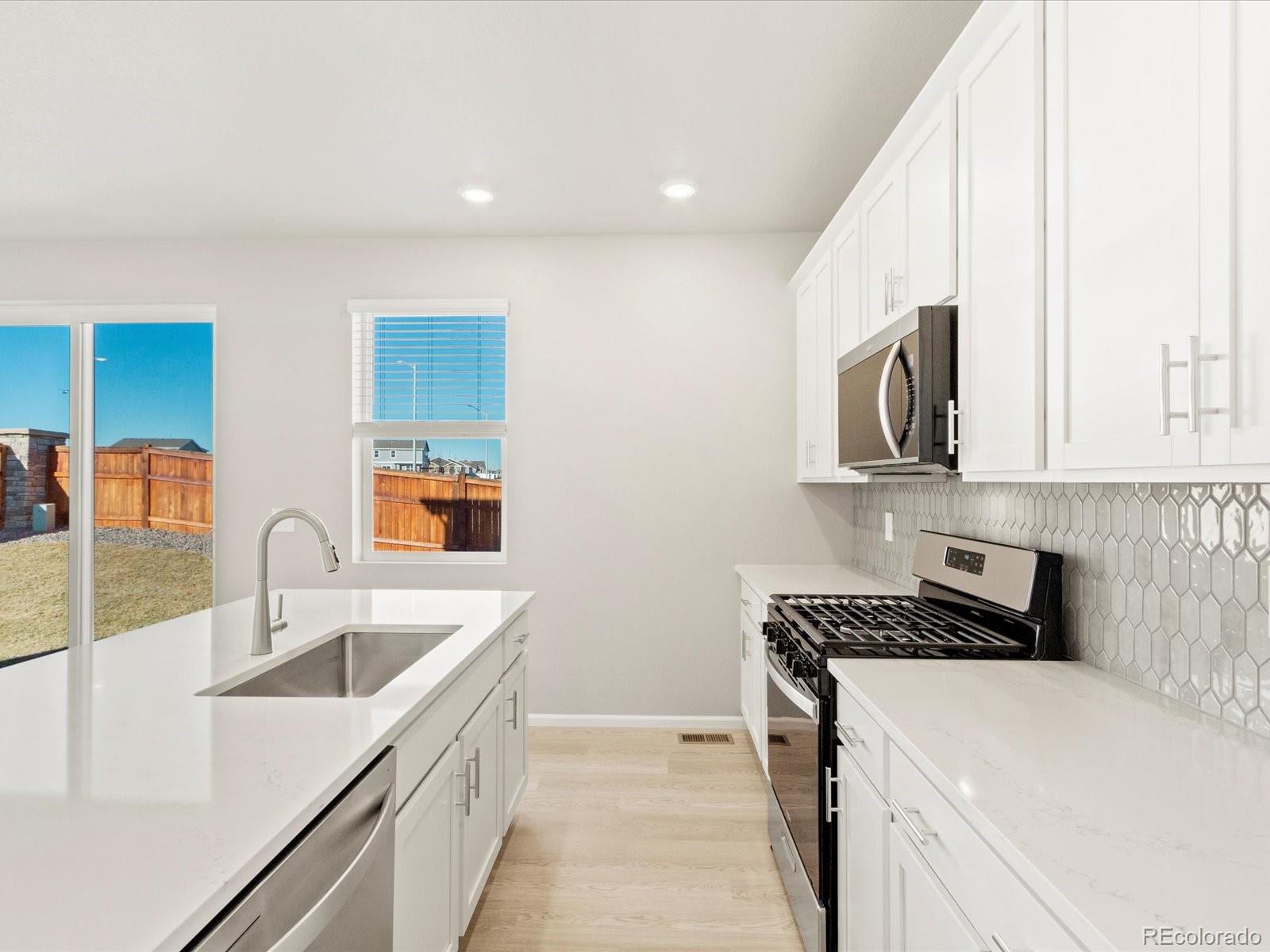 851 Frst Cyn Road Severance, CO 80550 - Photo 15 of 37 a kitchen that has a sink and a stove