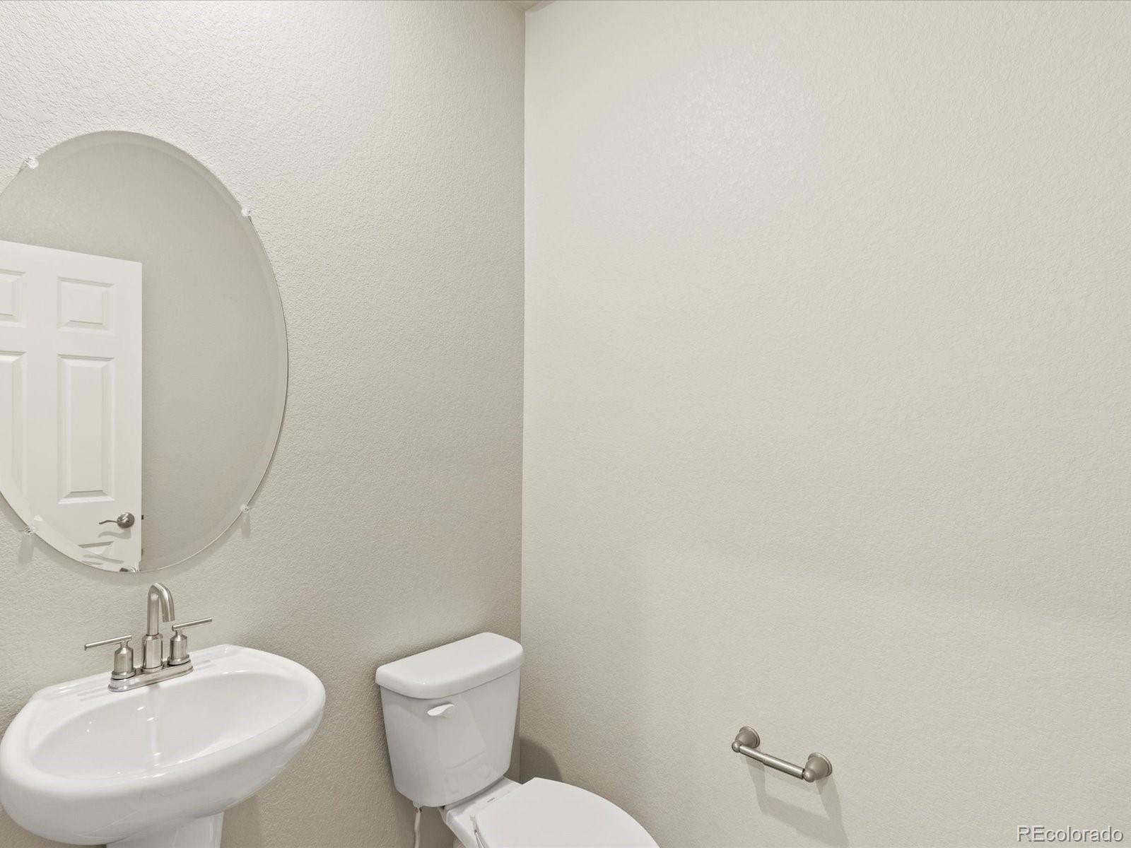 851 Frst Cyn Road Severance, CO 80550 - Photo 7 of 37 a bathroom with a toilet a sink and mirror