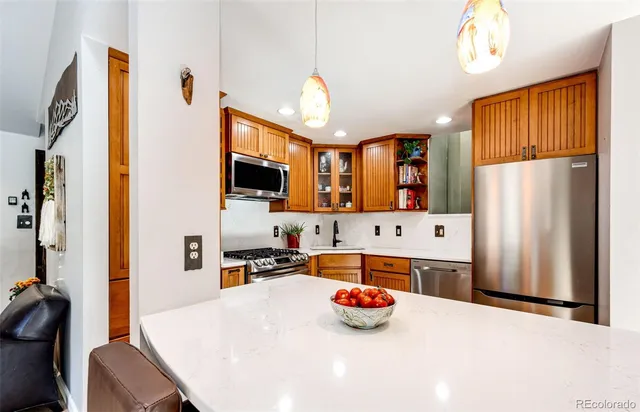 a kitchen with stainless steel appliances a stove sink and cabinets