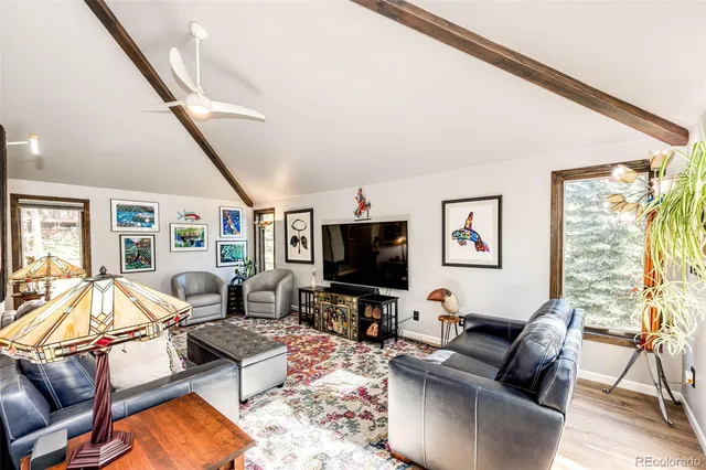 a living room with furniture flat screen tv and rug floor