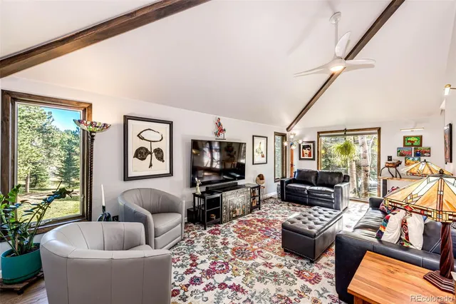 a living room with furniture wooden floor and a table