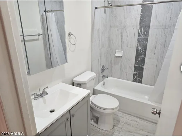 a bathroom with a sink a toilet a mirror and shower