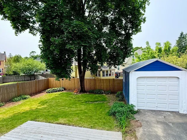 a front view of a house with a yard and trees