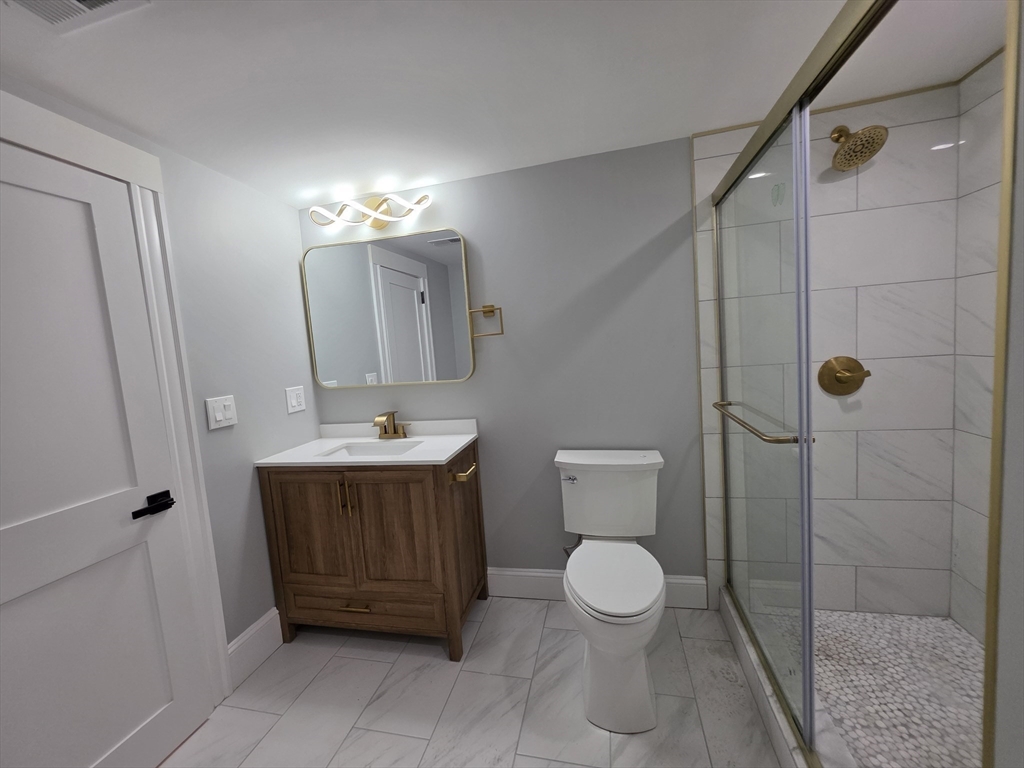 61 Poplar Street Danvers, MA 01923 - Photo 6 of 18 a bathroom with a sink a toilet and shower