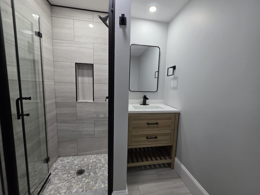 61 Poplar Street Danvers, MA 01923 - Photo 7 of 18 a bathroom with a sink shower and a mirror