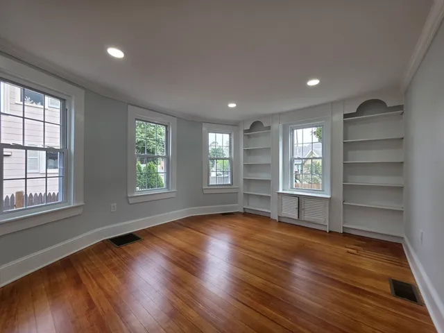 wooden floor in an empty room with a window