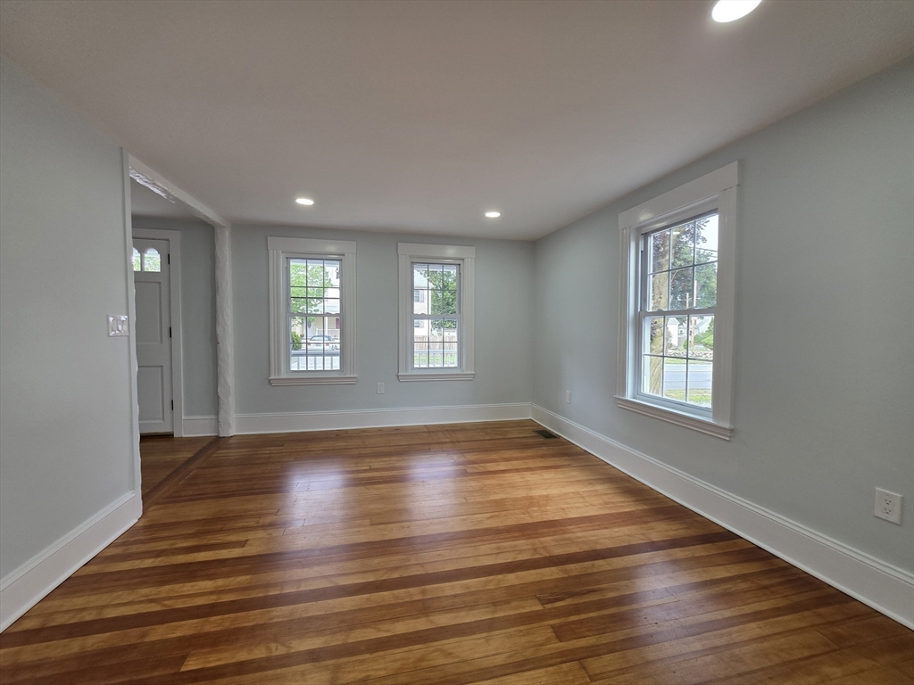 61 Poplar Street Danvers, MA 01923 - Photo 9 of 18 a view of an empty room with wooden floor and a window