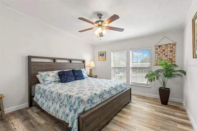 a bed sitting in a spacious bedroom next to a window