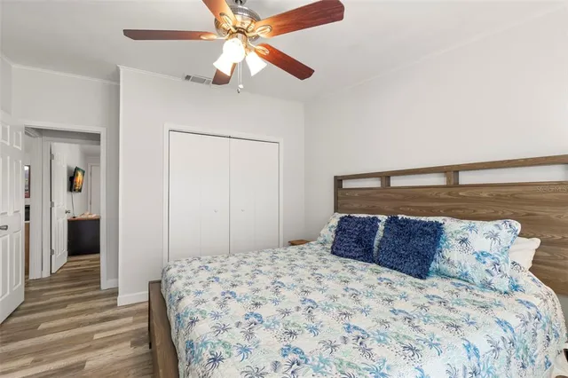 a bedroom with a bed and a chandelier