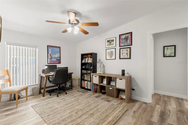 a view of a workspace with lounge chair and a window