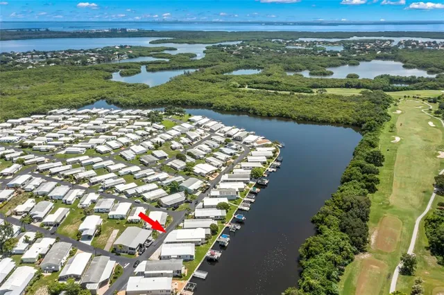 an aerial view of residential houses with outdoor space and lake view