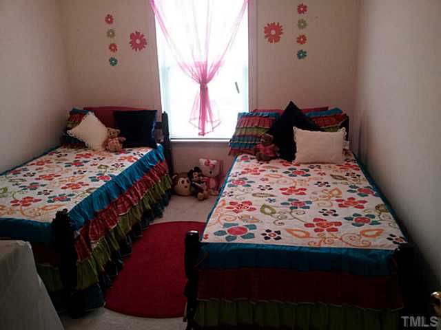 2052 Buffalo Way Durham, NC 27704 - Photo 12 of 20 a bedroom with a bed and a window