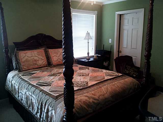 2052 Buffalo Way Durham, NC 27704 - Photo 14 of 20 a bed sitting in a bedroom next to a window