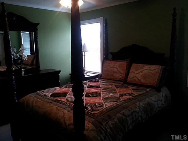 2052 Buffalo Way Durham, NC 27704 - Photo 15 of 20 a bed sitting in a bedroom next to a window